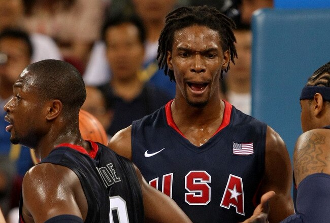 BEIJING - AUGUST 22:  Chris Bosh #12 of the United States reacts between teammates Dwyane Wade #9 and Carmelo Anthony #15 of the United States while taking on Argentina during a men's semifinal baketball game at the Wukesong Indoor Stadium on Day 14 of the Beijing 2008 Olympic Games on August 22, 2008 in Beijing, China.  (Photo by Jed Jacobsohn/Getty Images)