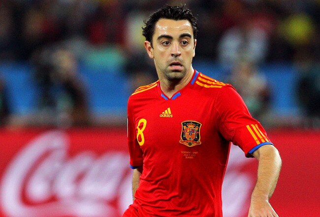 DURBAN, SOUTH AFRICA - JULY 07: Xavi Hernandez of Spain runs with the ball during the 2010 FIFA World Cup South Africa Semi Final match between Germany and Spain at Durban Stadium on July 7, 2010 in Durban, South Africa.  (Photo by Clive Rose/Getty Images)