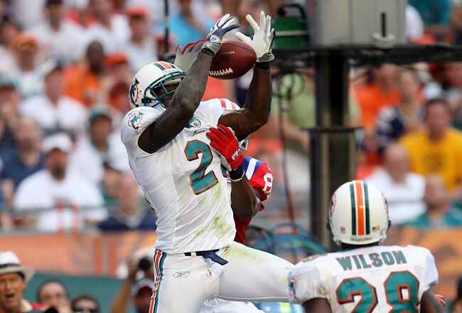 MIAMI - DECEMBER 06:  Cornerback Vontae Davis #21 of the Miami Dolphins intercepts a pass in the end-zone in front of wide receiver Randy Moss #81 of the New England Patriots at Land Shark Stadium on December 6, 2009 in Miami, Florida. The Dolphins defeated the Patriots 22-21.  (Photo by Doug Benc/Getty Images)