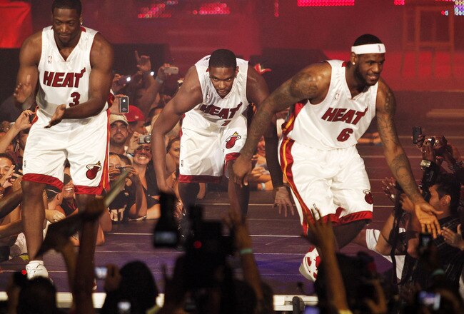 MIAMI - JULY 09:  Fans cheer as (L-R) Dwyane Wade #3, Chris Bosh #1 and LeBron James #6 of the Miami Heat are introduced during a welcome party at American Airlines Arena on July 9, 2010 in Miami, Florida.  (Photo by Marc Serota/Getty Images)