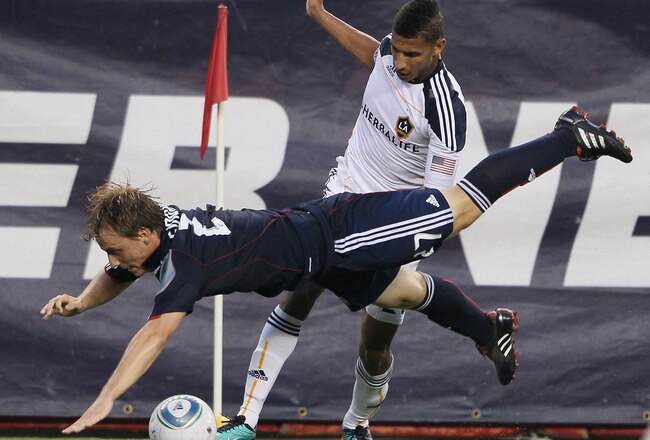 FOXBORO, MA - JULY 10:  Seth Sinovic #27 of the New England Revolution flies out of bounds as he tries to keep the ball from Sean Franklin #28 of the Los Angeles Galaxy on July 10, 2010 at Gillette Stadium in Foxboro, Massachusetts.  (Photo by Elsa/Getty Images)