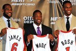 MIAMI - JULY 09:  LeBron James #6, Dwyane Wade #3 and Chris Bosh #1 of the Miami Heat show off their new game jerseys before a press conference after a welcome party at American Airlines Arena on July 9, 2010 in Miami, Florida.  (Photo by Doug Benc/Getty Images)