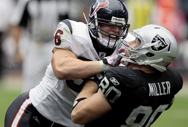 HOUSTON - OCTOBER 04:  Linebacker Brian Cushing #56 of the Houston Texans delivers a hard hit to tight-end Zach Miller #80 of the Oakland Raiders at Reliant Stadium on October 4, 2009 in Houston, Texas.  (Photo by Bob Levey/Getty Images)
