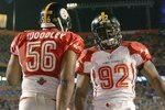 MIAMI GARDENS, FL - JANUARY 31: James Harrison #92 of the Pittsburgh Steelers celebrates with  LaMarr Woodley #56 of the Pittsburgh Steelers during the 2010 AFC-NFC Pro Bowl at Sun Life Stadium on January 31, 2010 in Miami Gardens, Florida. (Photo by Doug Benc/Getty Images)