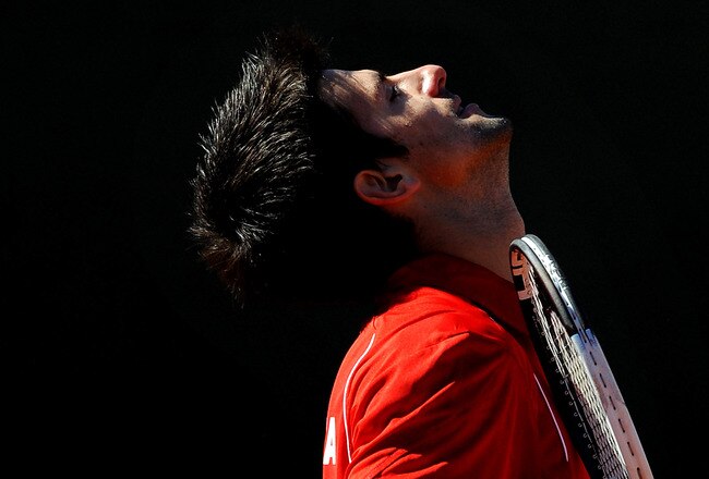 BENIDORM, SPAIN - MARCH 08:  Novak Djokovic of Serbia reacts after losing a point to Rafael Nadal of Spain during day two of the Davis Cup World Group first round tie between Spain and Serbia at the Parque Tematico Terra Mitica on March 8, 2009 in Benidorm, Spain. Nadal defeated Djokovic in three straight sets 6-4, 6-4 and 6-1 sending Spain into the Davis Cup quarter-finals with a 3-1 win over Serbia.  (Photo by Jasper Juinen/Getty Images)