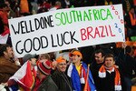 JOHANNESBURG, SOUTH AFRICA - JULY 11:  Netherlands fans enjoy the atmosphere prior to the 2010 FIFA World Cup South Africa Final match between Netherlands and Spain at Soccer City Stadium on July 11, 2010 in Johannesburg, South Africa.  (Photo by Clive Mason/Getty Images)