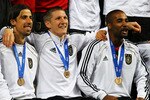 PORT ELIZABETH, SOUTH AFRICA - JULY 10:  (L-R) Sami Khedira, Bastian Schweinsteiger and Cacau of Germany celebrate victory and third place following the 2010 FIFA World Cup South Africa Third Place Play-off match between Uruguay and Germany at The Nelson Mandela Bay Stadium on July 10, 2010 in Port Elizabeth, South Africa.  (Photo by Lars Baron/Getty Images)