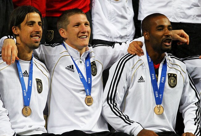 PORT ELIZABETH, SOUTH AFRICA - JULY 10:  (L-R) Sami Khedira, Bastian Schweinsteiger and Cacau of Germany celebrate victory and third place following the 2010 FIFA World Cup South Africa Third Place Play-off match between Uruguay and Germany at The Nelson Mandela Bay Stadium on July 10, 2010 in Port Elizabeth, South Africa.  (Photo by Lars Baron/Getty Images)