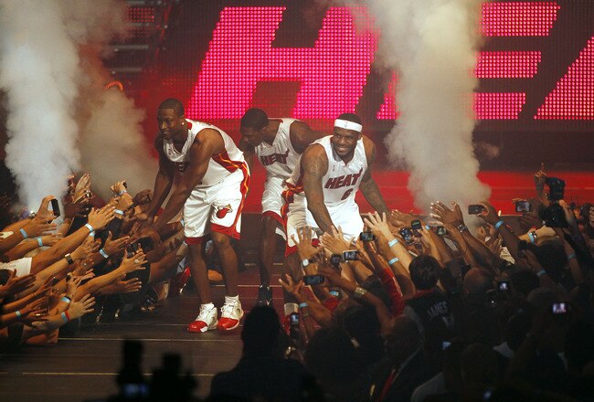 MIAMI - JULY 09:  Fans cheer as (L-R) Dwyane Wade #3, Chris Bosh #1 and LeBron James #6 of the Miami Heat are introduced during a welcome party at American Airlines Arena on July 9, 2010 in Miami, Florida.  (Photo by Marc Serota/Getty Images)
