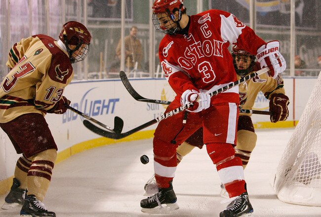 BOSTON - JANUARY 08:  Cam Atkinson #13 of the Boston College Eagles and Kevin Shattenkirk #3 of the Boston University Terriers fight for the puck on January 8, 2010 during the Sun Life Frozen Fenway Hockey Game at the Fenway Park in Boston, Massachusetts.  (Photo by Elsa/Getty Images)