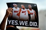 MIAMI - JULY 09:  A fan holds up a poster  of Chris Bosh #1, Dwyane Wade #3 and LeBron James #6 of the Miami Heat before the start of a welcome party for the new players at American Airlines Arena on July 9, 2010 in Miami, Florida.  (Photo by Doug Benc/Getty Images)