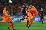 JOHANNESBURG, SOUTH AFRICA - JULY 11: Nigel De Jong of the Netherlands tackles Xabi Alonso of Spain during the 2010 FIFA World Cup South Africa Final match between Netherlands and Spain at Soccer City Stadium on July 11, 2010 in Johannesburg, South Africa.  (Photo by Laurence Griffiths/Getty Images)