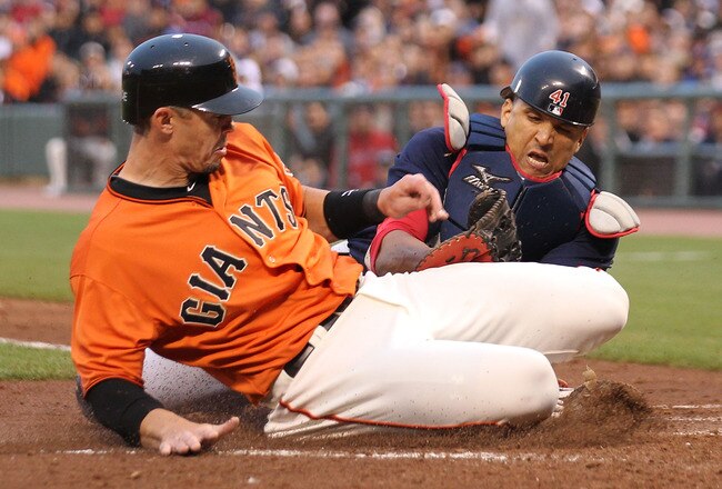 SAN FRANCISCO - JUNE 25:  Eli Whiteside #22 of the San Francisco Giants is tagged out at home by Victor Martinez #41 of the Boston Red Sox on a fielders choice hit by Andres Torres in the second inning during an MLB game at AT&T Park on June 25, 2010 in San Francisco, California.  (Photo by Jed Jacobsohn/Getty Images)