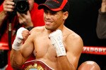 LAS VEGAS - DECEMBER 06:  (L-R) Juan Manuel Lopez of Puerto Rico celebrates after defeating Sergio Medina of Argentina during their WBO junior featherweight title fight at the MGM Grand Garden Arena December 6, 2008 in Las Vegas, Nevada.  (Photo by Ethan Miller/Getty Images)