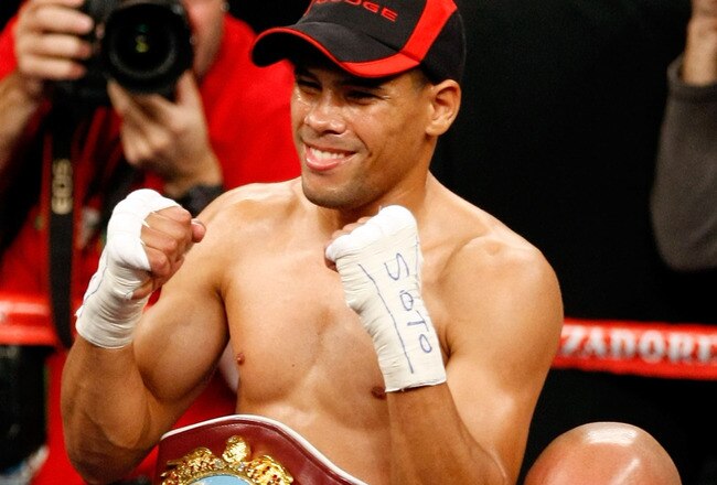 LAS VEGAS - DECEMBER 06:  (L-R) Juan Manuel Lopez of Puerto Rico celebrates after defeating Sergio Medina of Argentina during their WBO junior featherweight title fight at the MGM Grand Garden Arena December 6, 2008 in Las Vegas, Nevada.  (Photo by Ethan Miller/Getty Images)