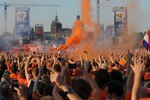 AMSTERDAM, NETHERLANDS - JULY 11:  Holland fans cheer and let off flares as they watch the FIFA2010 World Cup final between Netherlands and Spain on a large screen near the Rijksmuseum on July 11, 2010 in Amsterdam, Netherlands.  (Photo by Christopher Lee/Getty Images)