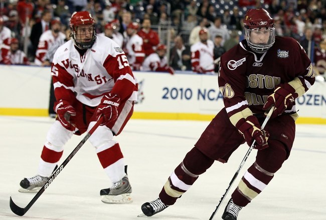 DETROIT - APRIL 10:   Jimmy Hayes #10 of the Boston College Eagles takes the puck as Craig Smith #15 of the Wisconsin Badgers defends during the championship game of the 2010 NCAA Frozen Four on April 10, 2010 at Ford Field in Detroit, Michigan. Boston College defeated Wisconsin 5-0 to win the national title.  (Photo by Elsa/Getty Images)