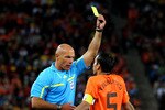 JOHANNESBURG, SOUTH AFRICA - JULY 11:  Referee Howard Webb issues Giovanni Van Bronckhorst of the Netherlands a yellow card during the 2010 FIFA World Cup South Africa Final match between Netherlands and Spain at Soccer City Stadium on July 11, 2010 in Johannesburg, South Africa.  (Photo by Lars Baron/Getty Images)