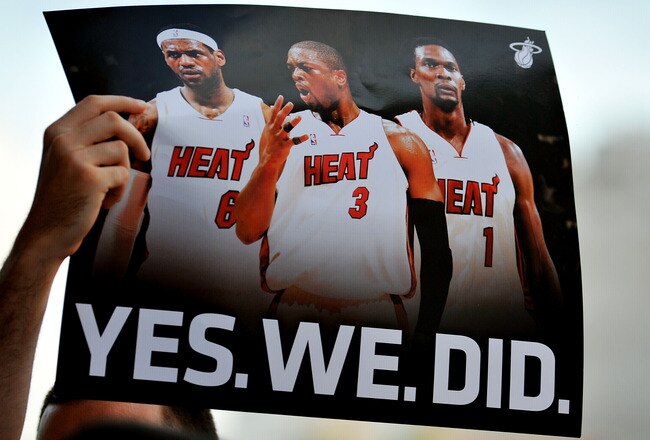 MIAMI - JULY 09:  A fan holds up a poster  of Chris Bosh #1, Dwyane Wade #3 and LeBron James #6 of the Miami Heat before the start of a welcome party for the new players at American Airlines Arena on July 9, 2010 in Miami, Florida.  (Photo by Doug Benc/Getty Images)