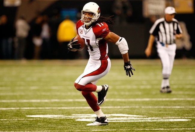 NEW ORLEANS - JANUARY 16:  Larry Fitzgerald #11 of the Arizona Cardinals runs for yards after the catch against the New Orleans Saints during the NFC Divisional Playoff Game at Louisana Superdome on January 16, 2010 in New Orleans, Louisiana. The Saints won 45-14.  (Photo by Ronald Martinez/Getty Images)