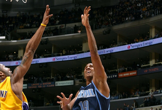 LOS ANGELES - FEBRUARY 15:  Raja Bell #19 of the Utah Jazz puts a shot up over Kobe Bryant #8 of the Los Angeles Lakers on February 15, 2005 at Staples Center in Los Angeles, California.  NOTE TO USER: User expressly acknowledges and agrees that, by downloading and/or using this Photograph, user is consenting to the terms and conditions of the Getty Images License Agreement.  (Photo by Lisa Blumenfeld/Getty Images)