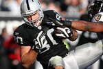 OAKLAND, CA - JANUARY 03: Zach Miller #80 of the Oakland Raiders catches a touchdown pass in the second quarter against the Baltimore Ravens during an NFL game at Oakland-Alameda County Coliseum on January 3, 2010 in Oakland, California.  (Photo by Jed Jacobsohn/Getty Images)