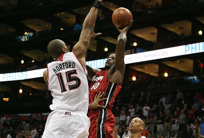 ATLANTA - MAY 03:  Joel Anthony #50 of the Miami Heat shoots over Al Horford #15 and Maurice Evans #1 of the Atlanta Hawks during Game Seven of the Eastern Conference Quarterfinals at Philips Arena on May 3, 2009 in Atlanta, Georgia. The Hawks defeated the Heat 91-78. NOTE TO USER: User expressly acknowledges and agrees that, by downloading and/or using this Photograph, user is consenting to the terms and conditions of the Getty Images License Agreement.  (Photo by Doug Benc/Getty Images)