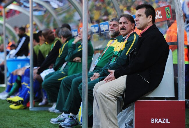 PORT ELIZABETH, SOUTH AFRICA - JULY 02:  Carlos Dunga head coach of Brazil sits on the bench with coaching staff ahead of the 2010 FIFA World Cup South Africa Quarter Final match between Netherlands and Brazil at Nelson Mandela Bay Stadium on July 2, 2010 in Nelson Mandela Bay/Port Elizabeth, South Africa.  (Photo by Laurence Griffiths/Getty Images)