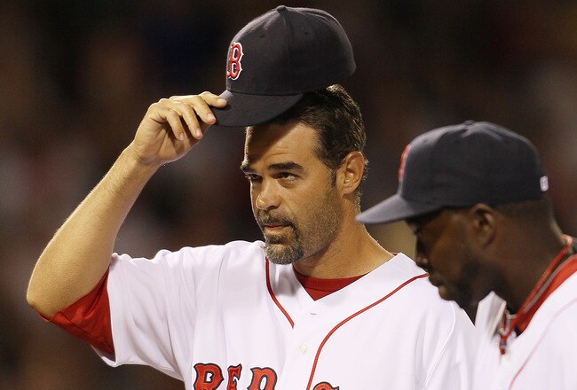 BOSTON - APRIL 04:  Mike Lowell #25 of the Boston Red Sox tips his hat to the fans during player introductions before the game against the New York Yankees on April 4, 2010 during Opening Night at Fenway Park in Boston, Massachusetts.  (Photo by Elsa/Getty Images)