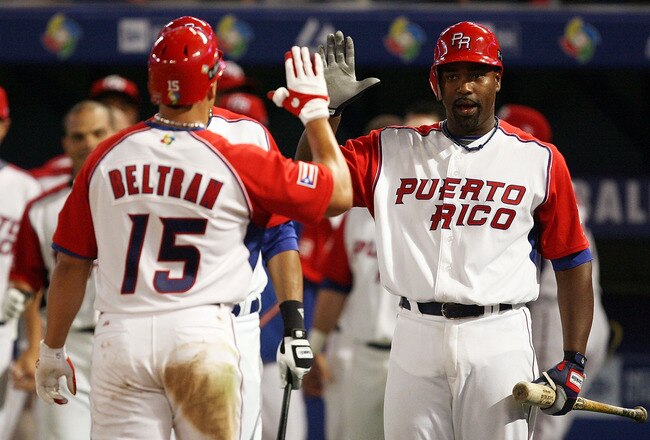 MIAMI - MARCH 14:  Carlos Delgado #21 of Puerto Rico congratulates Carlos Beltran #15 after Beltran's solo home run in the seventh inning against the United States during round 2 of the World Baseball Classic at Dolphin Stadium on March 14, 2009 in Miami, Florida. Puerto Rico defeated the United States 11-1 in seven innings.  (Photo by Doug Benc/Getty Images)