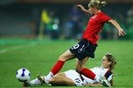 TIANJIN, CHINA - SEPTEMBER 22:  Kelly Smith of England battles for the ball with Leslie Osborne of United States during the Quarter Final of the Women's World Cup 2007 match between USA and England at Tianjin Olympic Center Stadium on September 22, 2007 in Tianjin, China.  (Photo by Paul Gilham/Getty Images)