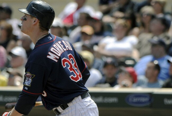 MINNEAPOLIS, MN - JUNE 30: Justin Morneau #33 of the Minnesota Twins watches the flight of his solo home run in the sixth inning against the Detroit Tigers during their game on June 30, 2010 at Target Field in Minneapolis, Minnesota. (Photo by Hannah Foslien /Getty Images)