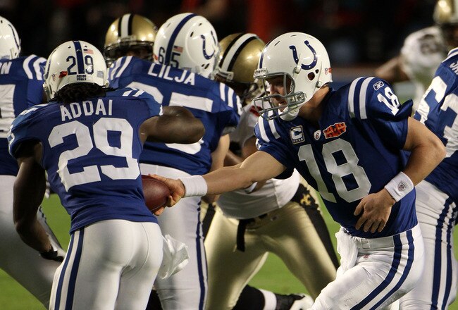MIAMI GARDENS, FL - FEBRUARY 07:  Quarterback Peyton Manning #18 of the Indianapolis Colts looks to hand off to #29 Joseph Addai against the New Orleans Saints during Super Bowl XLIV on February 7, 2010 at Sun Life Stadium in Miami Gardens, Florida.  (Photo by Elsa/Getty Images)