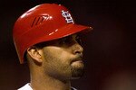 ST. LOUIS - JULY 2: Albert Pujols #5 of the St. Louis Cardinals reacts to striking out against the Milwaukee Brewers at Busch Stadium on July 2, 2010 in St. Louis, Missouri.  The Cardinals beat the Brewers 5-0.  (Photo by Dilip Vishwanat/Getty Images)
