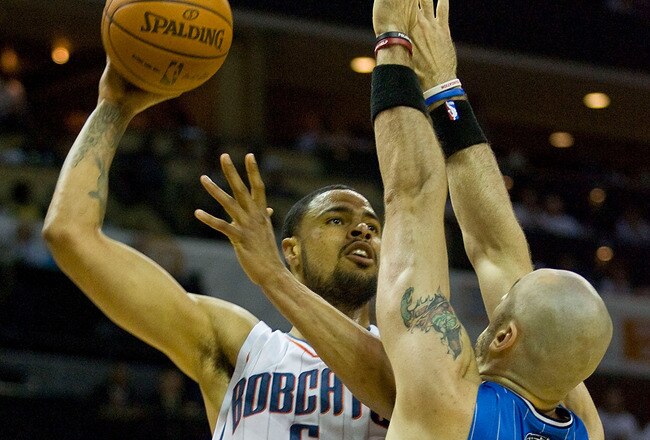 CHARLOTTE, NC - APRIL 26:  Tyson Chandler #6 of the Charlotte Bobcats shoots over Marcin Gortat #13 of the Orlando Magic in Game Four of the Eastern Conference Quarterfinals during the 2010 NBA Playoffs at Time Warner Cable Arena on April 26, 2010 in Charlotte, North Carolina. The Magic defeated the Bobcats 99-90 to complete the 4-game sweep.  NOTE TO USER: User expressly acknowledges and agrees that, by downloading and or using this photograph, User is consenting to the terms and conditions of the Getty Images License Agreement. (Photo by Brian A. Westerholt/Getty Images)