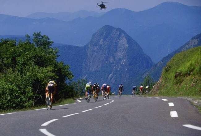 20 Jul 1999:  The peloton rides against the back-drop of the Pyrenees as a lone helicopter flies overhead during stage fifteen from St Gaudens to Piau-Engaly during the 1999 Tour De France.  Mandatory Credit: Doug Pensinger /Allsport