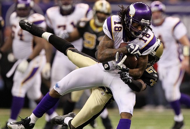NEW ORLEANS - JANUARY 24:  Sidney Rice #18 of the Minnesota Vikings makes a reception against Randall Gay #20 of the New Orleans Saints during the NFC Championship Game at the Louisiana Superdome on January 24, 2010 in New Orleans, Louisiana. The Saints won 31-28 in overtime.  (Photo by Jed Jacobsohn/Getty Images)