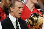DALLAS - JUNE 20:  Head coach Pat Riley of the Miami Heat is handed the trophy after game six of the 2006 NBA Finals on June 20, 2006 at American Airlines Center in Dallas, Texas. The Heat defeated the Mavericks 95-92 to win the NBA title.  NOTE TO USER: User expessly acknowledges and agrees that, by downloading and or using this photograph, User is consenting to the terms and conditions of the Getty Images License Agreement.  (Photo by Stephen Dunn/Getty Images)