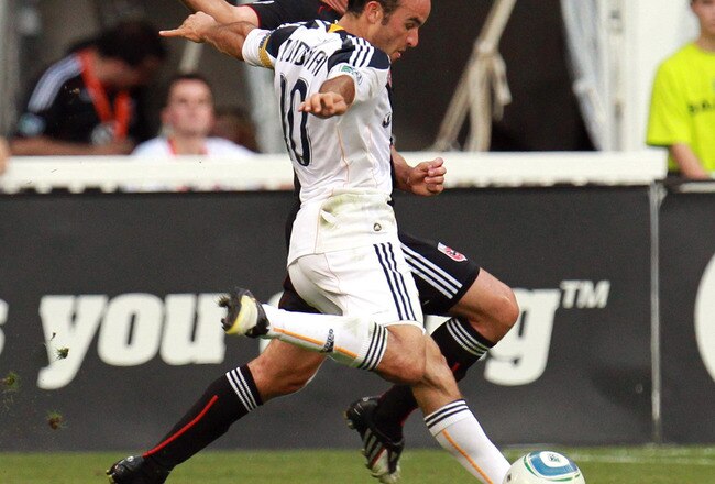 WASHINGTON - JULY 18: Landon Donovan #10 of the Los Angeles Galaxy shoots the ball against Devon McTavish #18 of D.C. United at RFK Stadium on July 18, 2010 in Washington, DC. (Photo by Ned Dishman/Getty Images)
