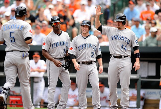 BALTIMORE - JULY 18:  Yunel Escobar #5 of the Toronto Blue Jays is congratulated by Fred Lewis #15, Aaron Hill #2 and John Buck #14 after hitting a grand slam home run in the second inning against the Baltimore Orioles at Camden Yards on July 18, 2010 in Baltimore, Maryland.  (Photo by Greg Fiume/Getty Images)