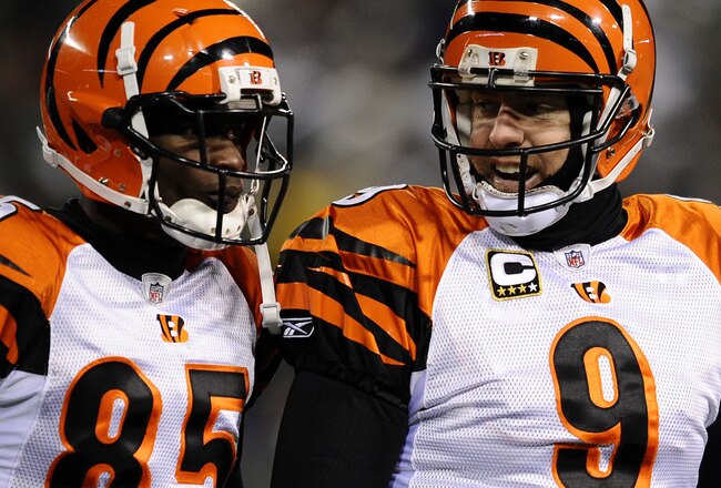 EAST RUTHERFORD, NJ - JANUARY 03:  Quarterback Carson Palmer #9 of the Cincinnati Bengals talks with teammate Chad Ochocinco #85 during the game against the New York Jets at Giants Stadium on January 3, 2010 in East Rutherford, New Jersey.  (Photo by Jeff Zelevansky/Getty Images)