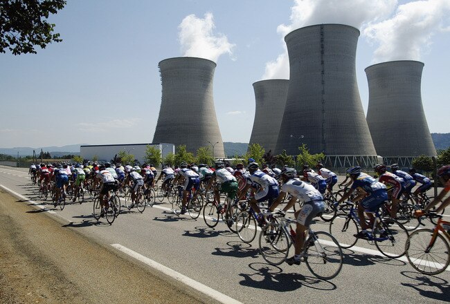 MORZINE-AVORIAZ, FRANCE - JULY 12:  The peloton rides past a nuclear power plant during stage seven, between Lyon and Morzine-Avoriaz, of the Tour de France on July 12, 2003 in France.  (Photo by Robert Laberge/Getty Images)