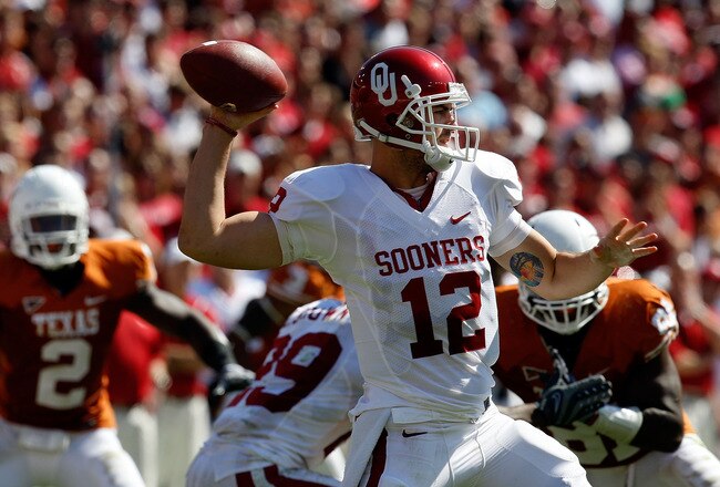 DALLAS - OCTOBER 17:  Quarterback Landry Jones #12 of the Oklahoma Sooners drops back to pass against the Texas Longhorns at Cotton Bowl on October 17, 2009 in Dallas, Texas.  (Photo by Ronald Martinez/Getty Images)