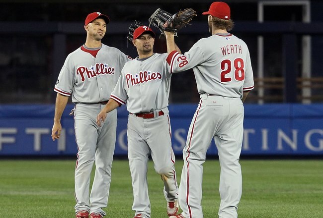 NEW YORK - JUNE 17: (L-R) Raul Ibanez #29, Shane Victorino #8, and Jayson Werth #28 of the Philadelphia Phillies celebrate after defeating the New York Yankees on June 17, 2010 at Yankee Stadium in the Bronx borough of New York City. The Phillies defeated the Yankees 7-1.  (Photo by Jim McIsaac/Getty Images)