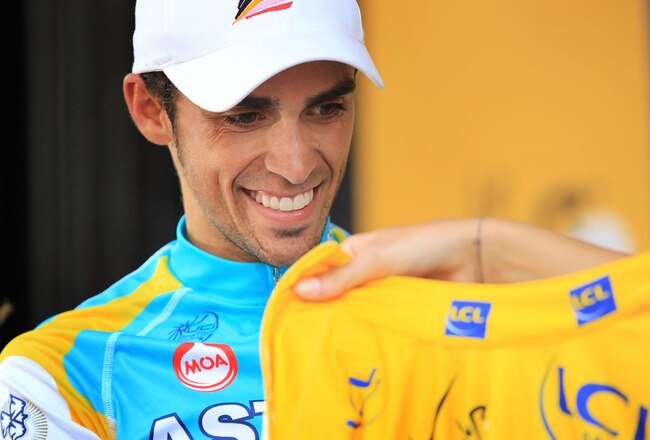 BAGNERES-DE-LUCHON, FRANCE - JULY 19:  Spaniard Alberto Contador puts on the yellow jersey after obtaining it from Luxembourg's Andy Schleck following stage 15 of the Tour de France on July 19, 2010 in Bagnères-de-Luchon, France. The 187.5km stage from Pamiers to Bagnères-de-Luchon featured two major climbs and the 1755m Port de Balès climb near the end of the stage. Bbox rider Thomas Voeckler, the National Champion of France, won the stage.  (Photo by Spencer Platt/Getty Images)