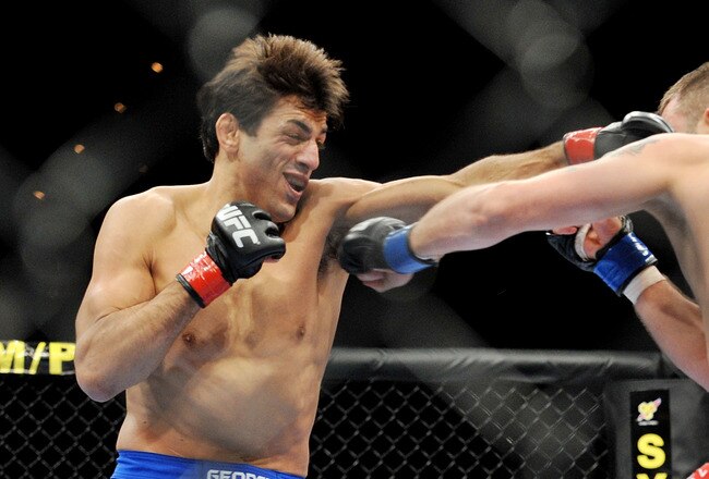 LAS VEGAS - NOVEMBER 21: George Sotiropoulos (L) battles Jason Dent (R) during their Lightweight Fight at the UFC 106 at Mandalay Bay Events Center on November 21, 2009 in Las Vegas, Nevada. (Photo by Jon Kopaloff/Getty Images)