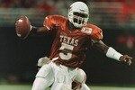 7 Dec 1996:  Quarterback James Brown #5 of the University of Texas Longhorns is flushed from the pocket by Jamel Williams #28 of the University of Nebraska Cornhuskers during the first quarter of the inaugural Dr. Pepper Big 12 Championship game at the TW