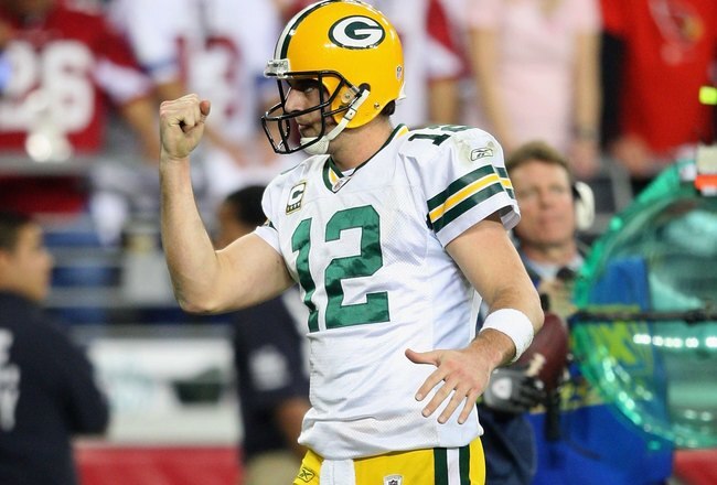 GLENDALE, AZ - JANUARY 10:  Quarterback Aaron Rodgers #12 of the Green Bay Packers celebrates a touchdown during the 2010 NFC wild-card playoff game against the Arizona Cardinals at the Universtity of Phoenix Stadium on January 10, 2010 in Glendale, Arizona.  The Cardinals defeated the Packers  51-45 in overtime.  (Photo by Christian Petersen/Getty Images)