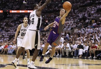 SAN ANTONIO - MAY 07:  Guard Steve Nash #13 of the Phoenix Suns takes a shot against Antonio McDyess #34 of the San Antonio Spurs in Game Three of the Western Conference Semifinals during the 2010 NBA Playoffs at AT&T Center on May 7, 2010 in San Antonio, Texas. NOTE TO USER: User expressly acknowledges and agrees that, by downloading and or using this photograph, User is consenting to the terms and conditions of the Getty Images License Agreement.  (Photo by Ronald Martinez/Getty Images)