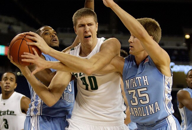DETROIT - DECEMBER 03:  Tom Herzog #40 of the Michigan State Spartans grabs a rebound while defended Marc Campbell #2 and Patrick Moody #35  of the North Carolina Tar Heels on December 3, 2008 at Ford Field in Detroit, Michigan.  North Carolina won 98-63.  (Photo by Andy Lyons/Getty Images)